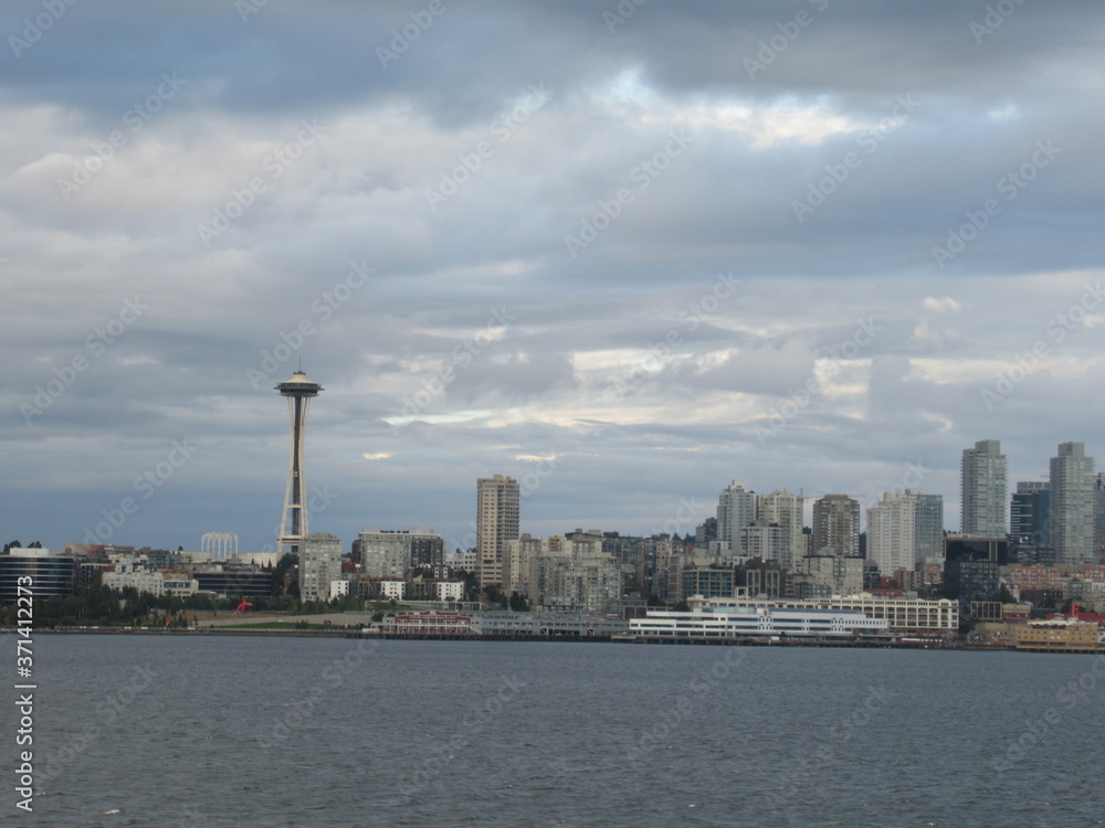 Fototapeta premium Space Needle and part of Seattle skyline seen from the sea on a cloudy evening. 
