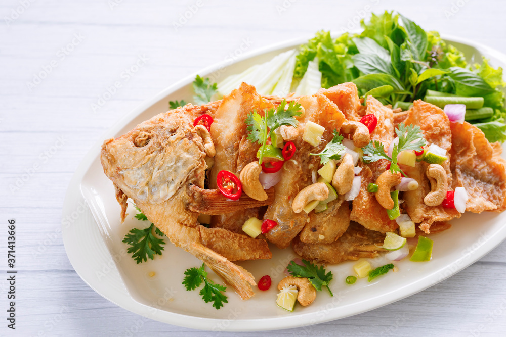 Fried Fish with herb and spicy sauce thai food. Fried Fish with herb and spicy sauce thai food.