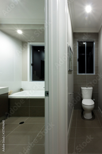 A modern bathroom interior with separate toilet