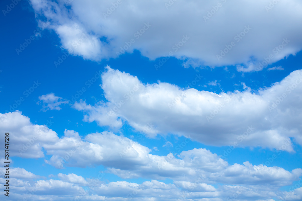 Blue sky and white clouds. Beautiful nature background. Summer vibes. Blue sky and white clouds. Beautiful nature background. Summer vibes.