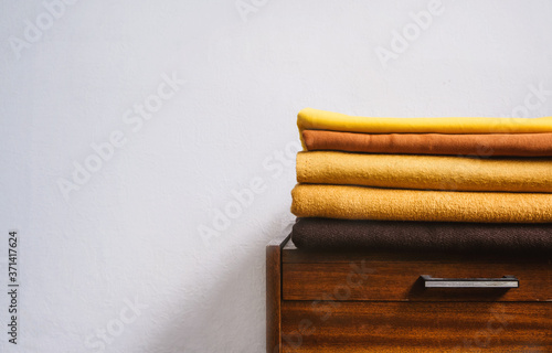 Fall autumn Minimalism, simple, Neutral color negative space background mockup with copy space. Fall autumn color palettes compositions with stack of yellow brown fabrics photo