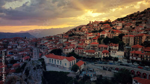 Aerial drone photo of beautiful sunset with golden colours and clouds over picturesque and traditional village of Arachova, Viotia prefecture, Greece