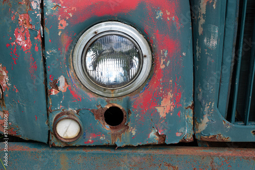 Circular headlight on an old rusted truck in Broome County NY