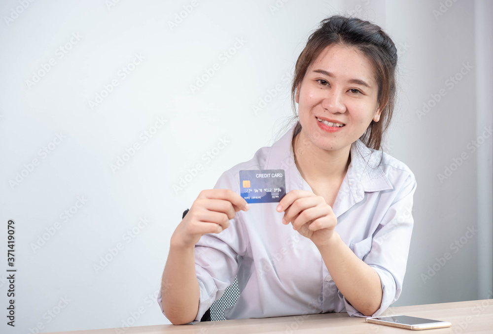 Portrait of young Asian woman smiling face holding credit card, online payment concept. Portrait of young Asian woman smiling face holding credit card, online payment concept.
