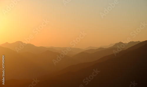 beautiful mountain sunset with fog and peaks © Mikhail