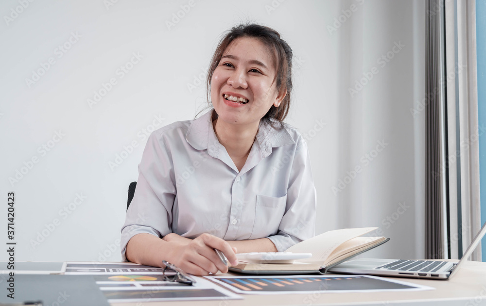 Portrait beautiful asian businesswoman working in her home, office, looking at graphs, financial markets, her business, and paying much attention. Portrait beautiful asian businesswoman working in her home, office, looking at graphs, financial markets, her business, and paying much attention.