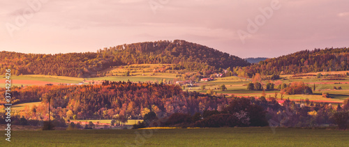 Fototapeta Naklejka Na Ścianę i Meble -  Hills bathed in the rays of the setting sun.