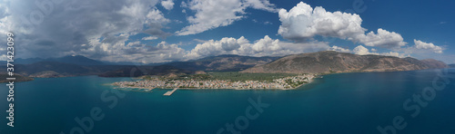 Aerial drone panoramic photo of picturesque seaside town of Itea built in the slopes of mount Parnassos, Fokida, Greece