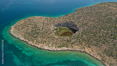 Fototapeta Naklejka Na Ścianę i Meble -  Aerial drone photo of volcanic crater formed thousand years ago by meteorite that fell near tropical exotic coast