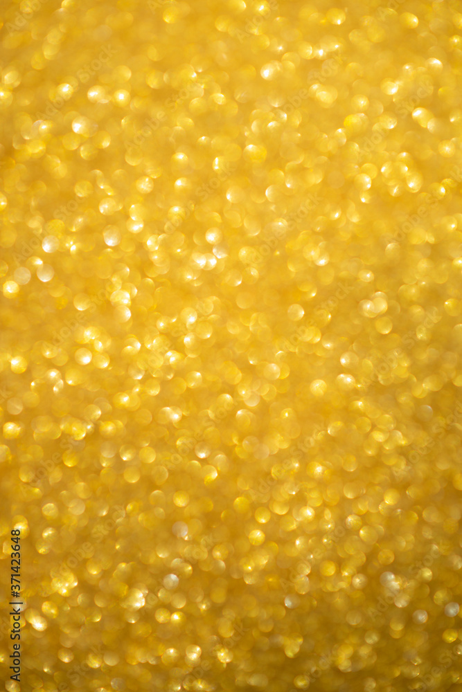 Gold glitter sparkles with bokeh effect. Festive background with bright golden lights. Christmas mood concept. Copy space texture, flat lay. Defocus blur. Gold glitter sparkles with bokeh effect. Festive background with bright golden lights. Christmas mood concept. Copy space texture, flat lay. Defocus blur.