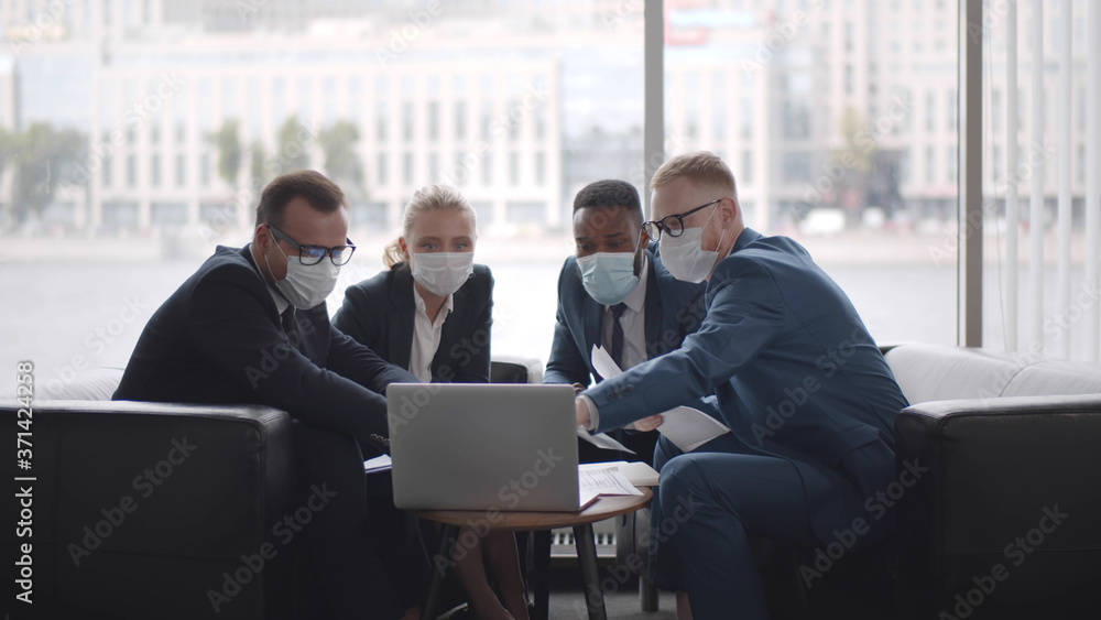 Diverse business team in protective masks working in modern office Diverse business team in protective masks working in modern office
