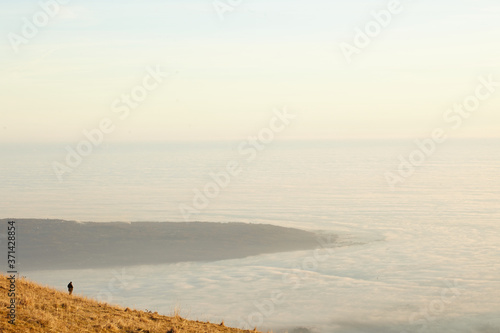 Lonely man walking over the top and panorama photo