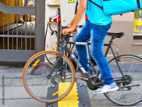 Temporary cable route on the street. The cyclist is out of focus.