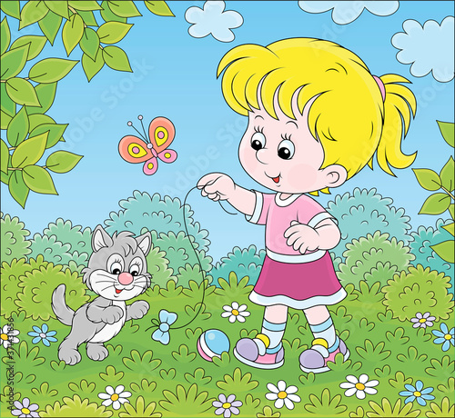 Smiling little girl playing with a small grey kitten among flowers on green grass of a lawn on a sunny summer day, vector cartoon illustration