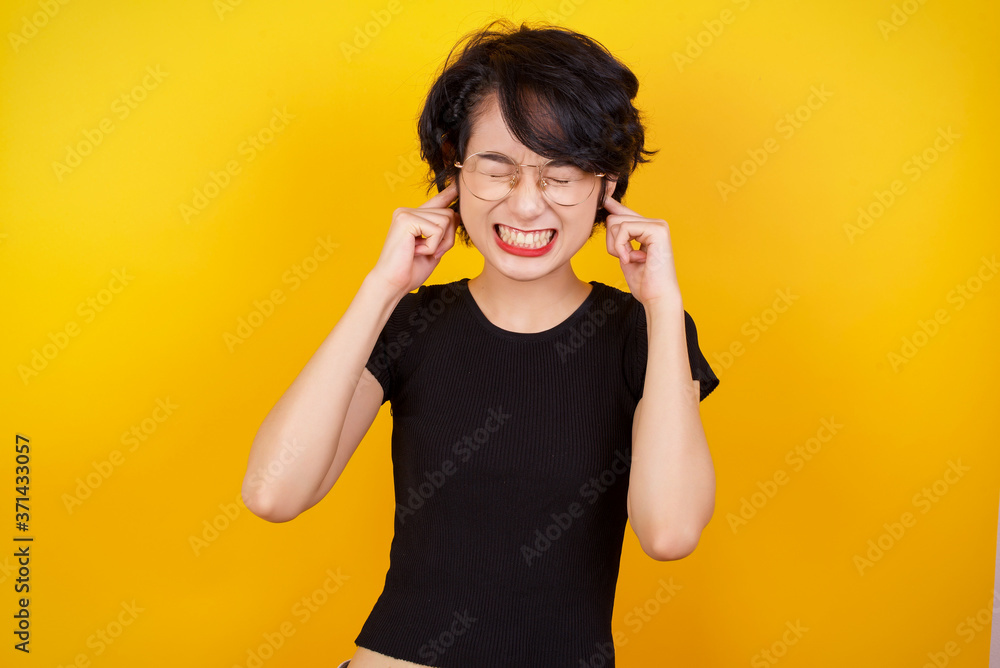 Stop making this annoying sound! Headshot of unhappy stressed out young female making worry face, plugging ears with fingers, irritated with loud noise coming from neighbours who live above her. Stop making this annoying sound! Headshot of unhappy stressed out young female making worry face, plugging ears with fingers, irritated with loud noise coming from neighbours who live above her.