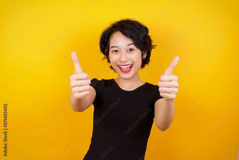 Good job! Portrait of a happy smiling blue eyed young successful woman giving two thumbs up gesture standing indoors. Positive human emotion facial expression body language. Funny girl Good job! Portrait of a happy smiling blue eyed young successful woman giving two thumbs up gesture standing indoors. Positive human emotion facial expression body language. Funny girl
