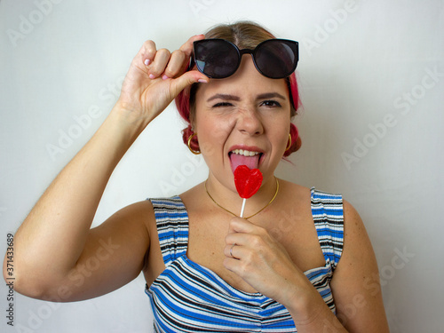 Bad woman eating the lollipop on white background