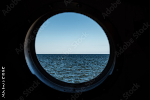 Minesweeper porthole with baltic sea view. Selective focus