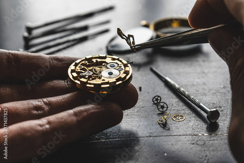 Watchmaker is repearing mechanical wrist watch