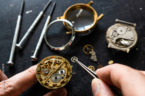 Watchmaker is repearing mechanical wrist watch
