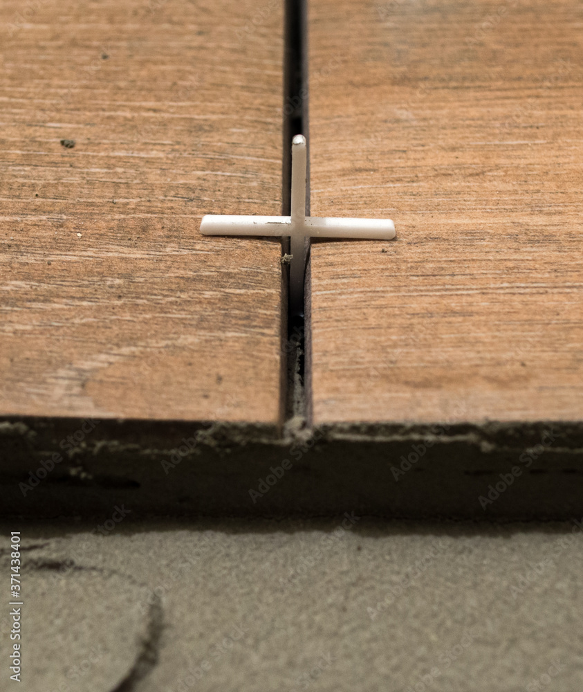 plastic cross for leveling tiles during construction or renovation. floor tile repair