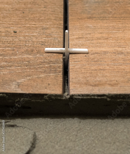 plastic cross for leveling tiles during construction or renovation. floor tile repair