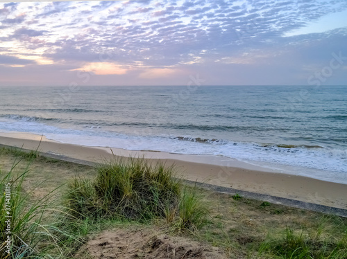 View over Cart Gap beac from high up in the sand dunes  just as the sun starts to set.