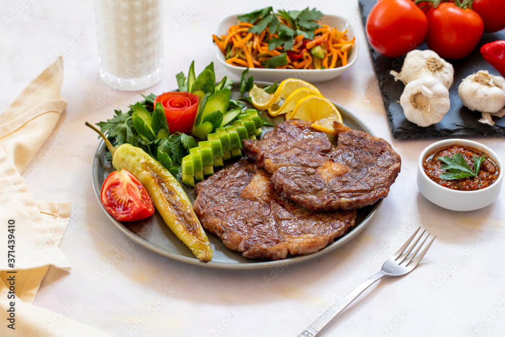 Isolated grilled beef steak on a wooden board Isolated grilled beef steak on a wooden board