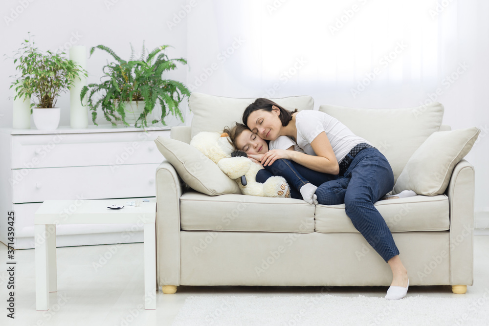 Smiling mother and daughter laying together in the living room. Smiling mother and daughter laying together in the living room.