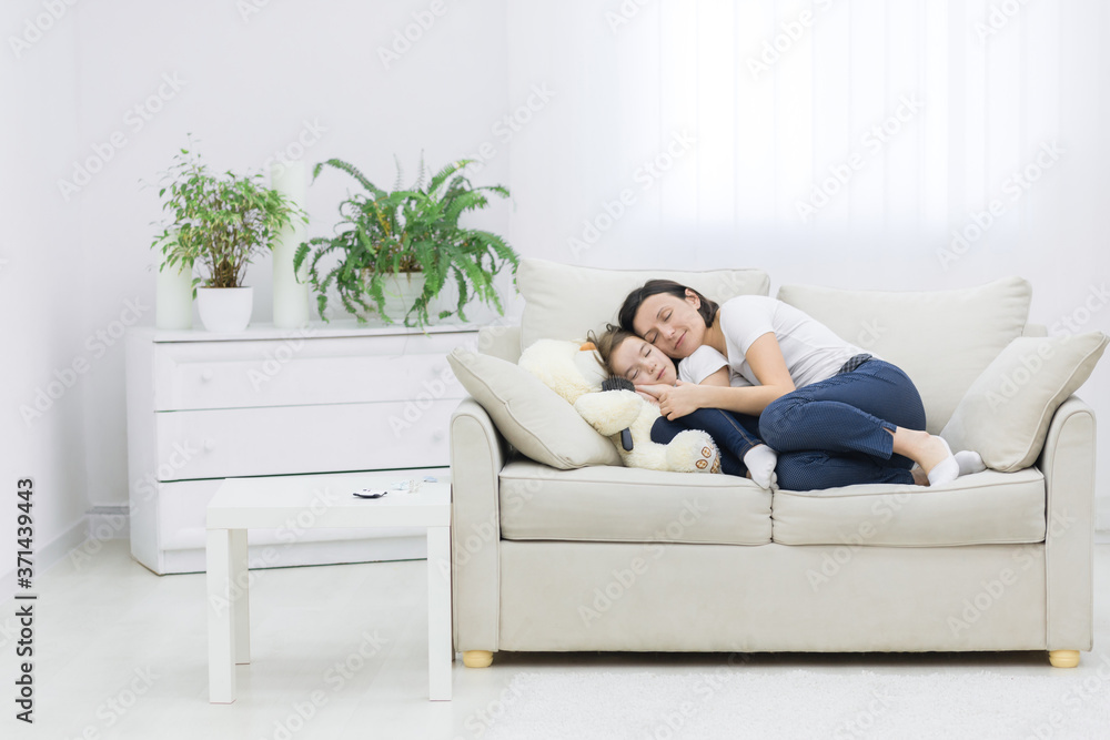 Smiling mother and daughter laying together in the living room. Smiling mother and daughter laying together in the living room.