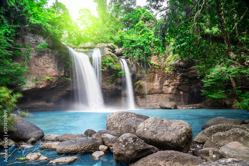 Fototapeta Naklejka Na Ścianę i Meble -  Travel to the beautiful waterfall in deep forest, soft water of the stream in the natural park at Haew Suwat Waterfall at Khao Yai National Park, Thailand