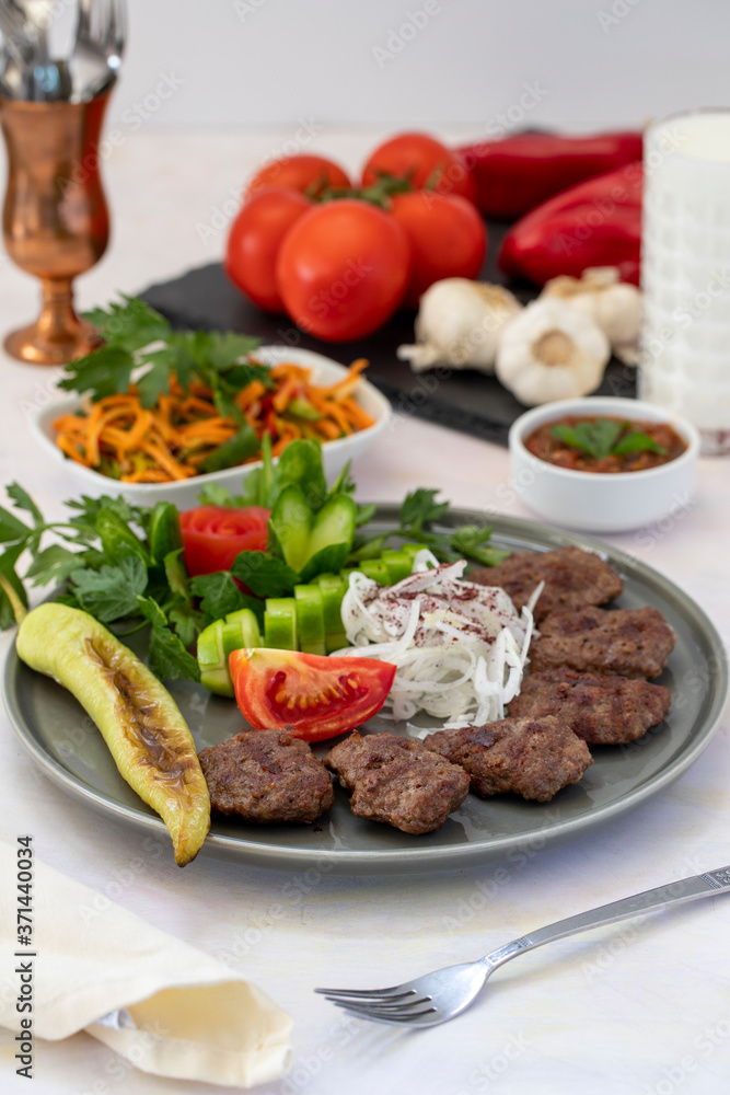 Delicious Turkish traditional kebab meatballs on white plate. Turkish Food Kofte or Kofta (meatball). Delicious Turkish traditional kebab meatballs on white plate. Turkish Food Kofte or Kofta (meatball).