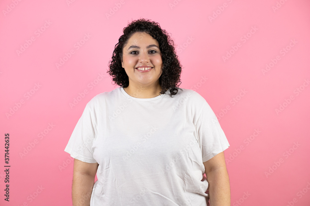 Young beautiful woman standing over isolated pink background smiling Young beautiful woman standing over isolated pink background smiling