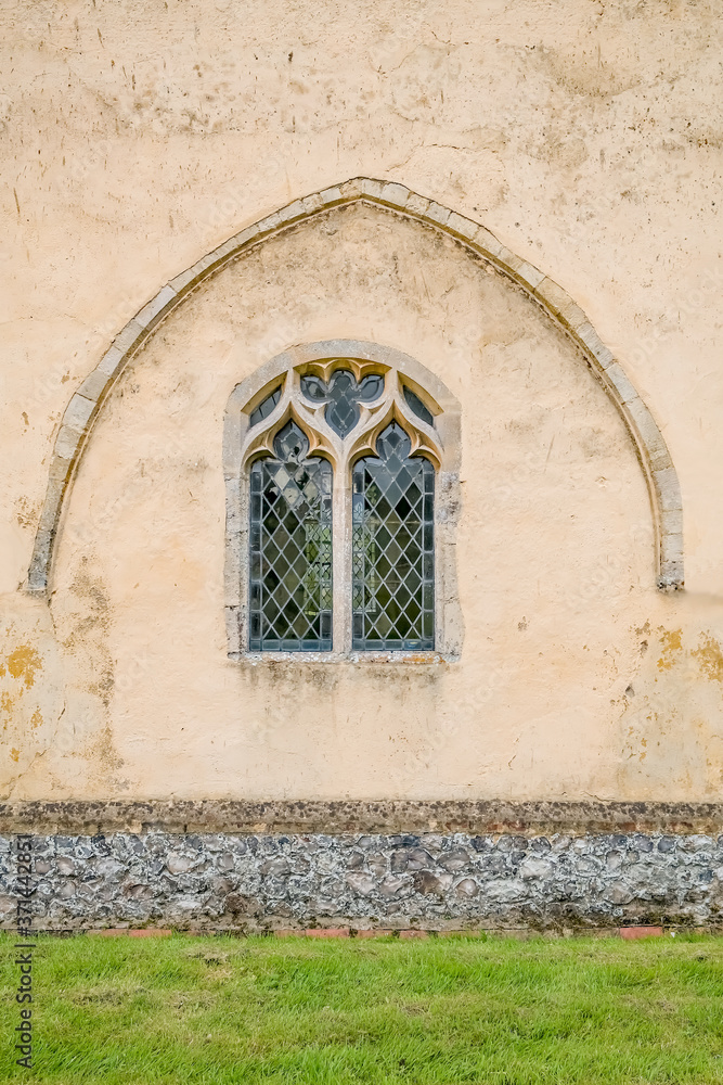 Ornate patterned window under a concrete arch in the porch of a Norfolk church Ornate patterned window under a concrete arch in the porch of a Norfolk church