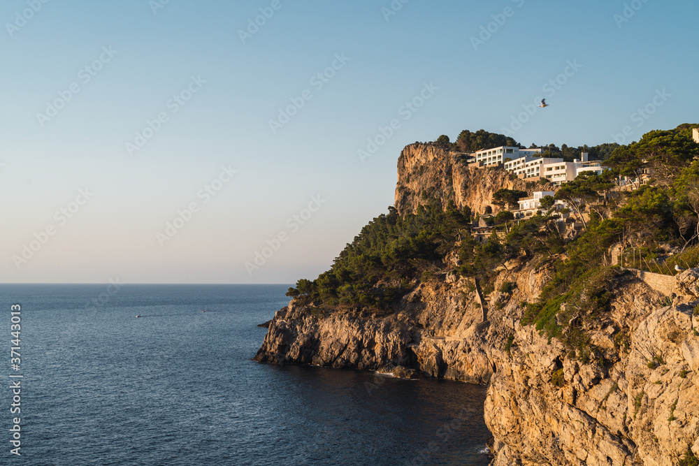 View from a viewpoint at Soller (Serra de Tramuntana, Mallorca, Spain) of a cliff and a luxury hotel on the top of it