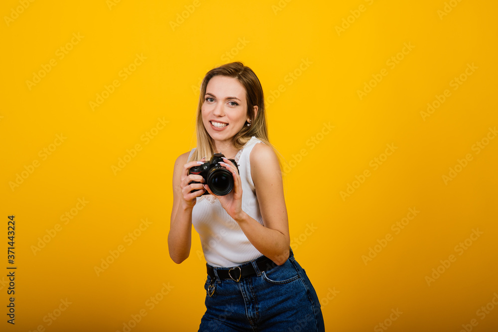 Excited female photographer working in studio. Portrait of stunning blonde girl with photo camera. Excited female photographer working in studio. Portrait of stunning blonde girl with photo camera.