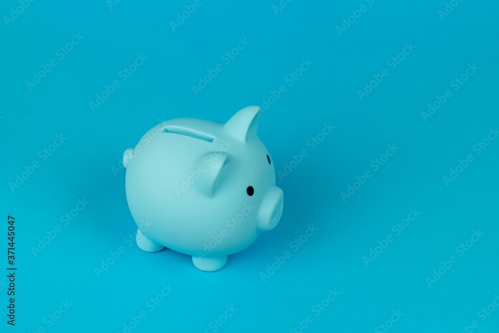 piggy bank in the form of a pig on a blue background, copy spaсe		