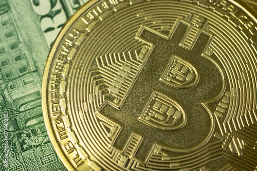 Macro photo of bitcoin logo on background with money