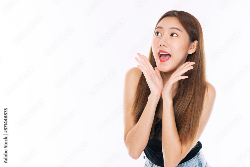 Young woman with surprised excited screaming while looking at product on sale promotion over isolated white background. Cheerful girl funny joyful face shouting wow expression with copy space. Young woman with surprised excited screaming while looking at product on sale promotion over isolated white background. Cheerful girl funny joyful face shouting wow expression with copy space.