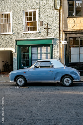 A classic and vintage small  blue car with a white roof parked down a quie t side street in the city of Norwich, Norfolk © yackers1