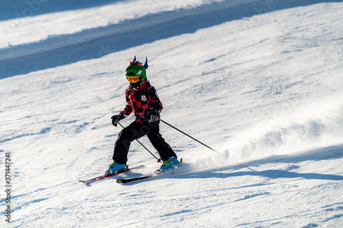 Happy Boy with Ski Helmet and Googles on a Ski Slope