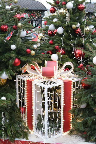 Journey to Christmas Festival 2020 in Moscow city, Russia. New Year decor, Christmas decoration on street. New Year fir-tree with lights and garlands on Orekhovy Boulevard. Holiday mood. Present box photo