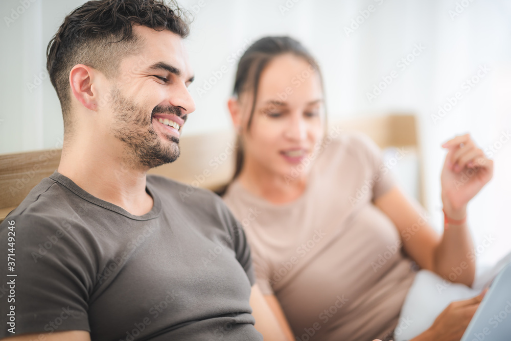 couple working on bed with laptop and tablet, work from home concept