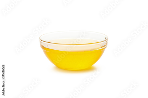 Glass bowl of honey isolated on white background