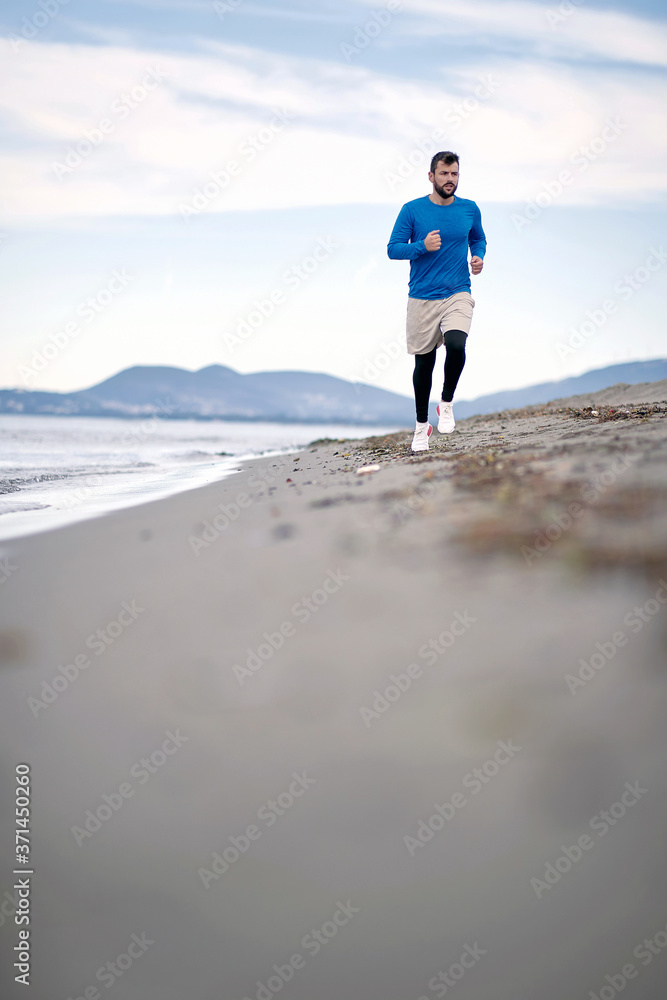 Man jogging on the beach; Healthy lifestyle concept
