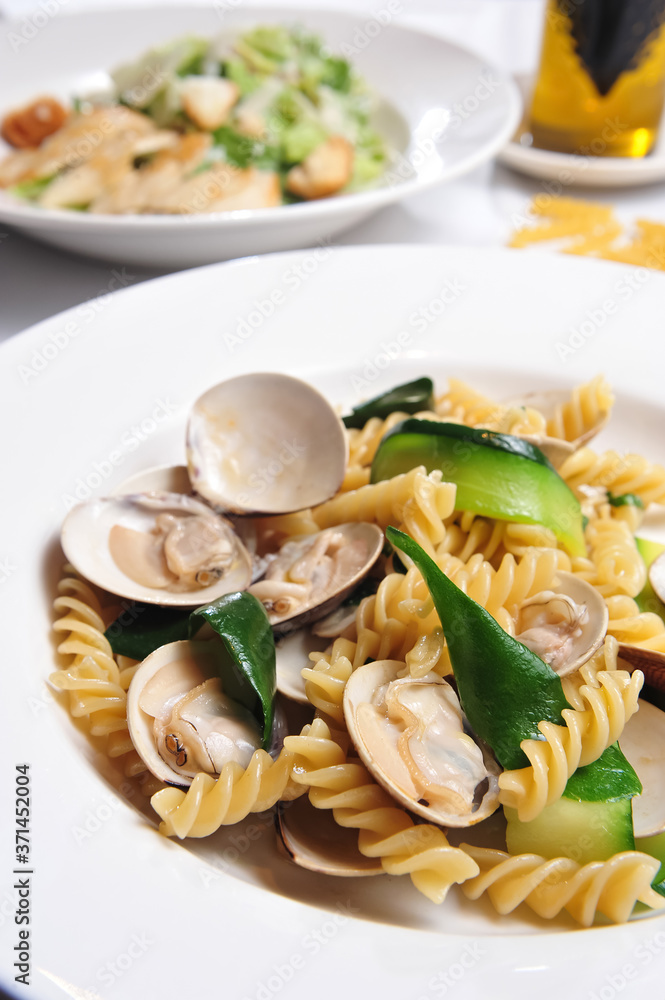 A Dish Of Fried Clams, Cucumber Slices And Fusilli Pasta A Dish Of Fried Clams, Cucumber Slices And Fusilli Pasta