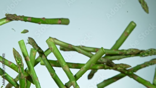 Super Slow Motion Shot of Flying Asparagus, Collision in the Air at 1000fps. photo