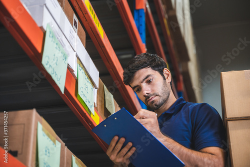Male warehouse worker worki...