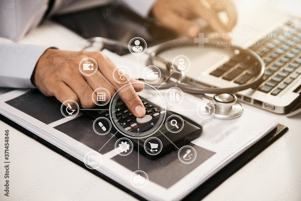 Doctor working in hospital use calculator, Healthcare and medical concept. Doctor working in hospital use calculator, Healthcare and medical concept.
