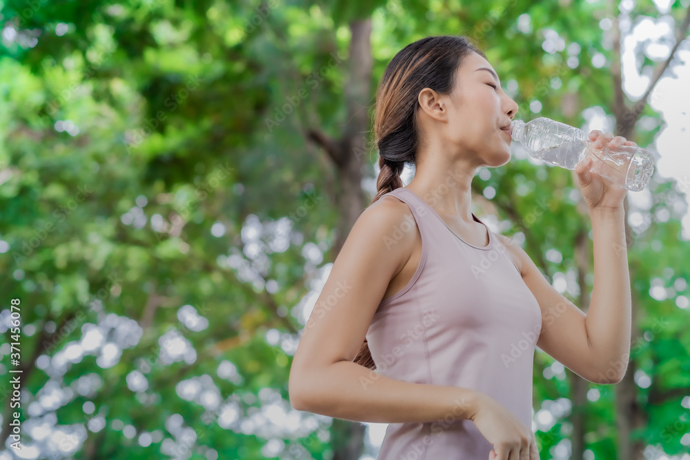 Young women drinking a water after running and excercise. Young women drinking a water after running and excercise.
